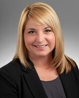 Headshot of Rebecca Pulkrabek wearing dark clothes with blonde hair